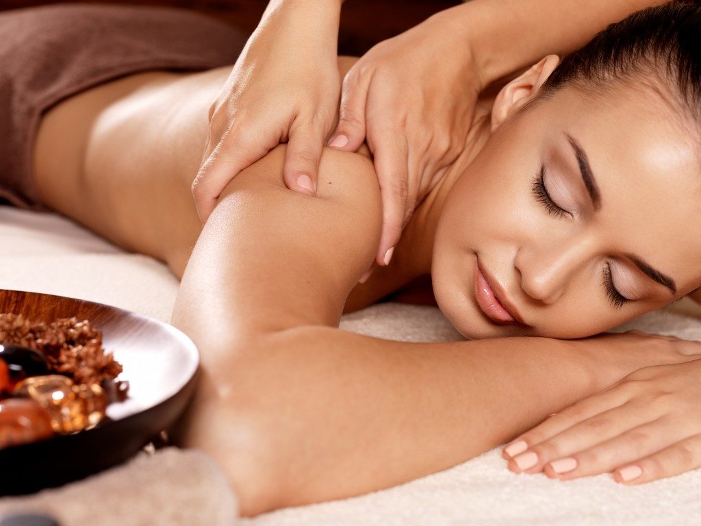 woman enjoying massage at spa