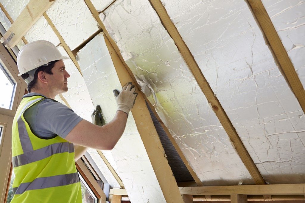 man installing insulation