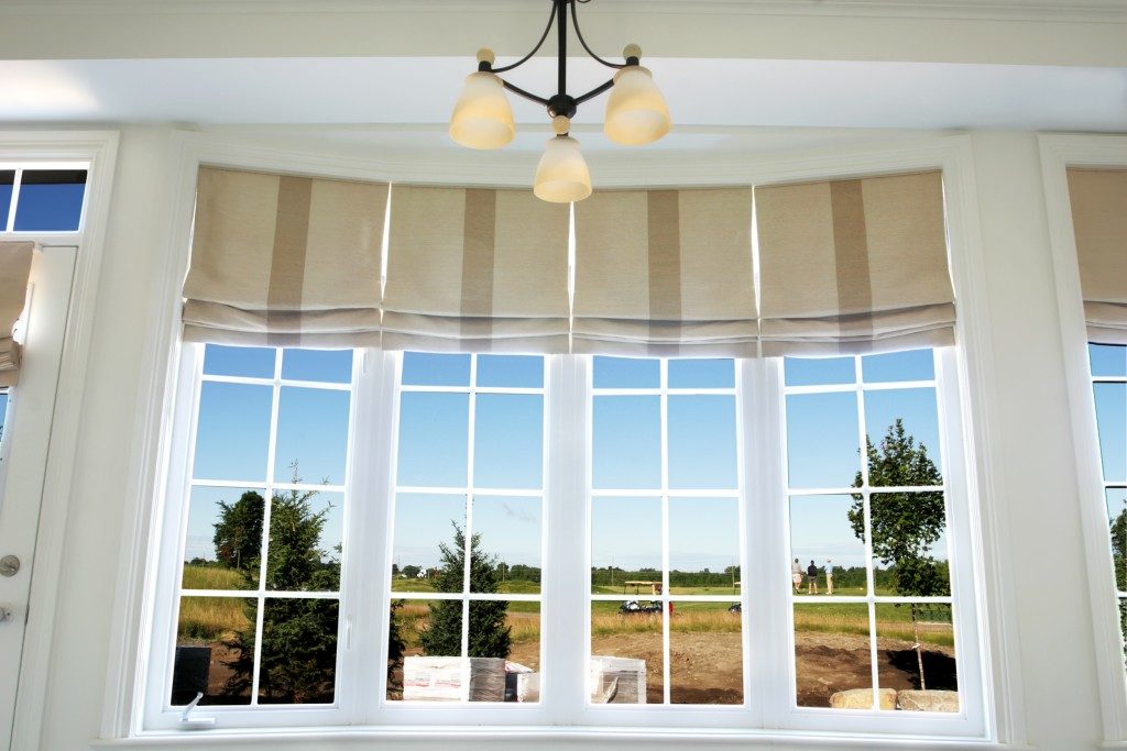 Interior of a model home showing drapery using roman shades