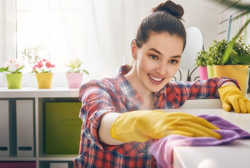 Woman wiping and cleaning surface