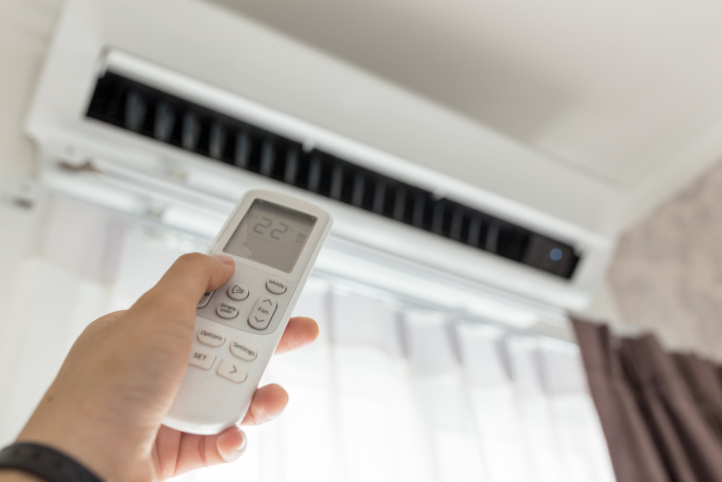 man turning on air conditioner