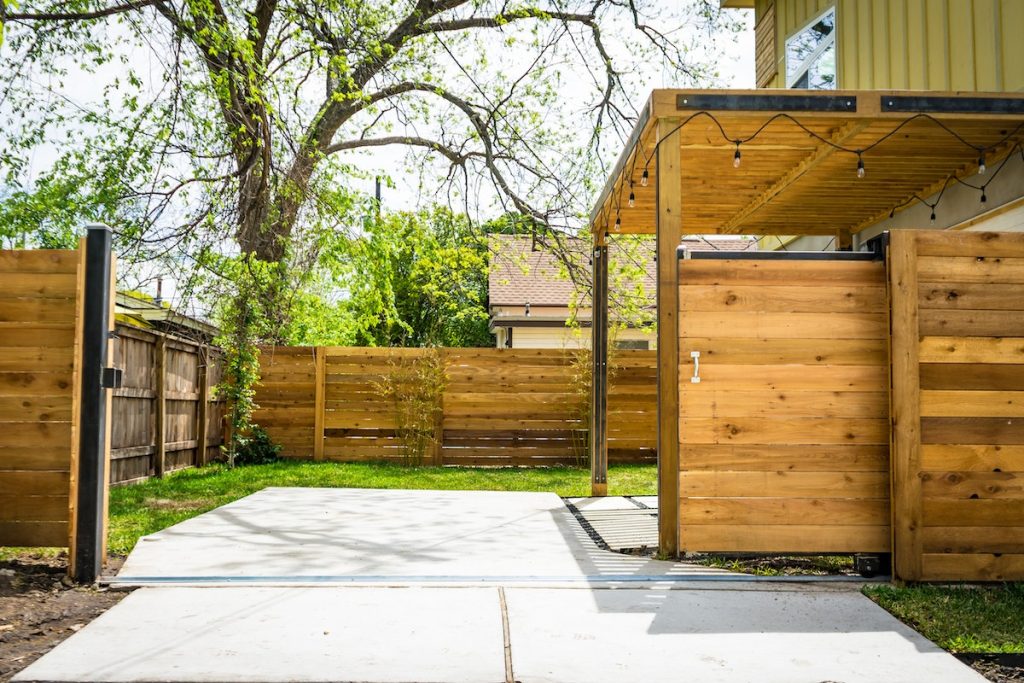 Photo of Opened Brown Wooden Sliding House Gate