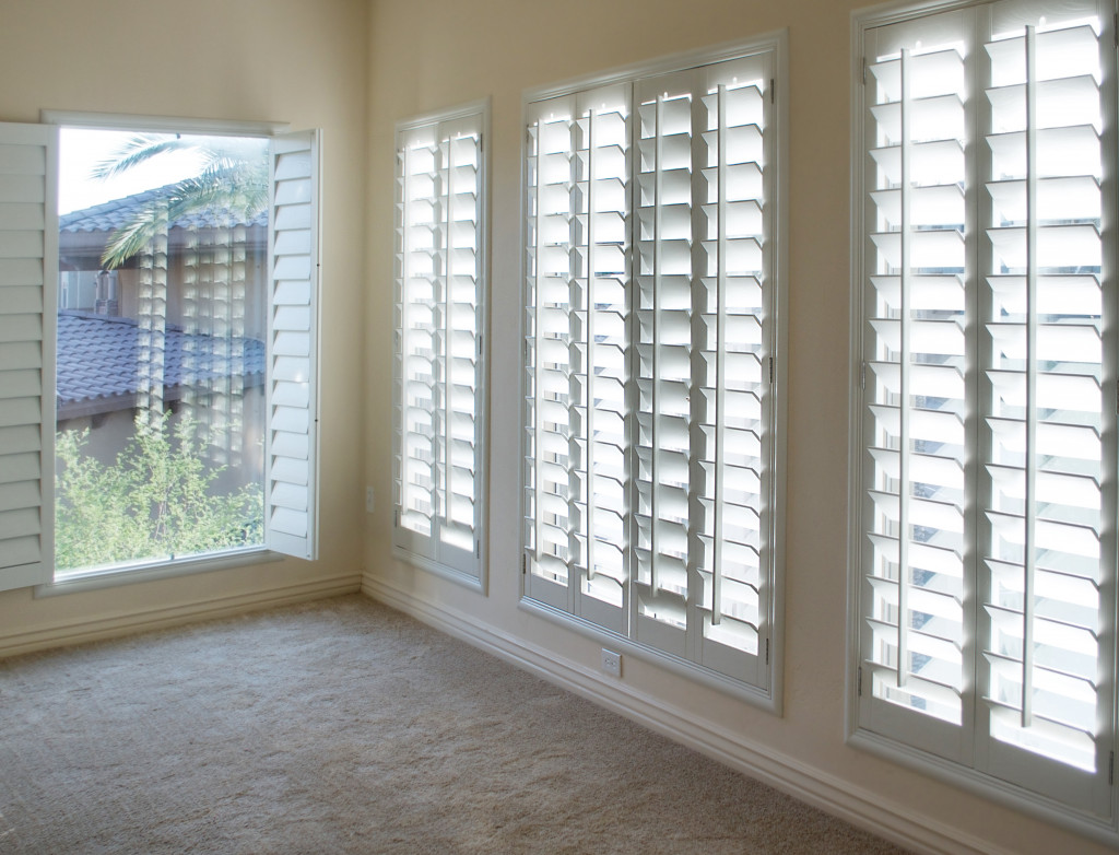 White plantation shutters in an empty room