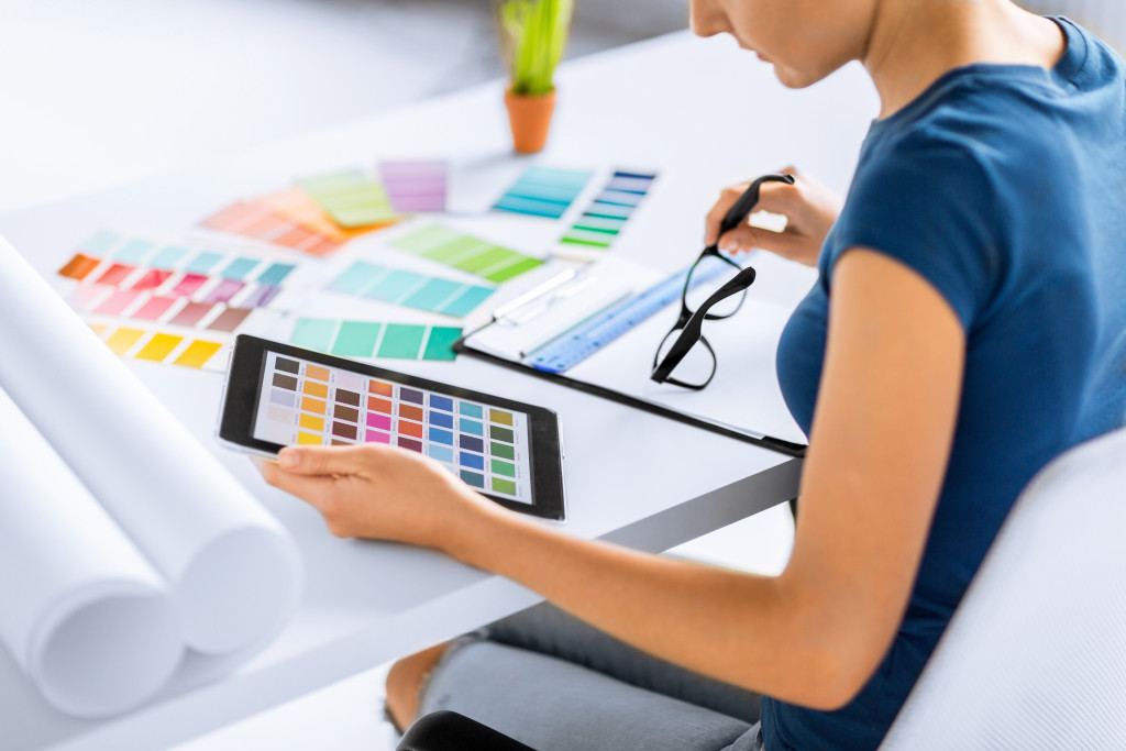 A woman looking at color swatches on a tablet