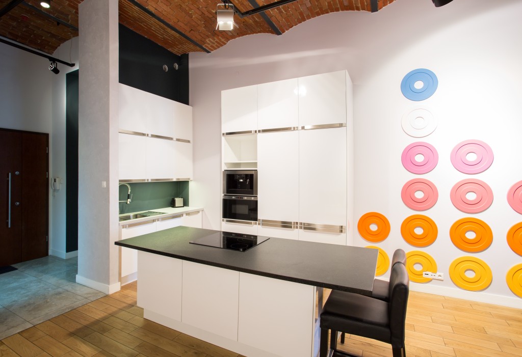Small kitchen decorated with colorful circles on the wall.