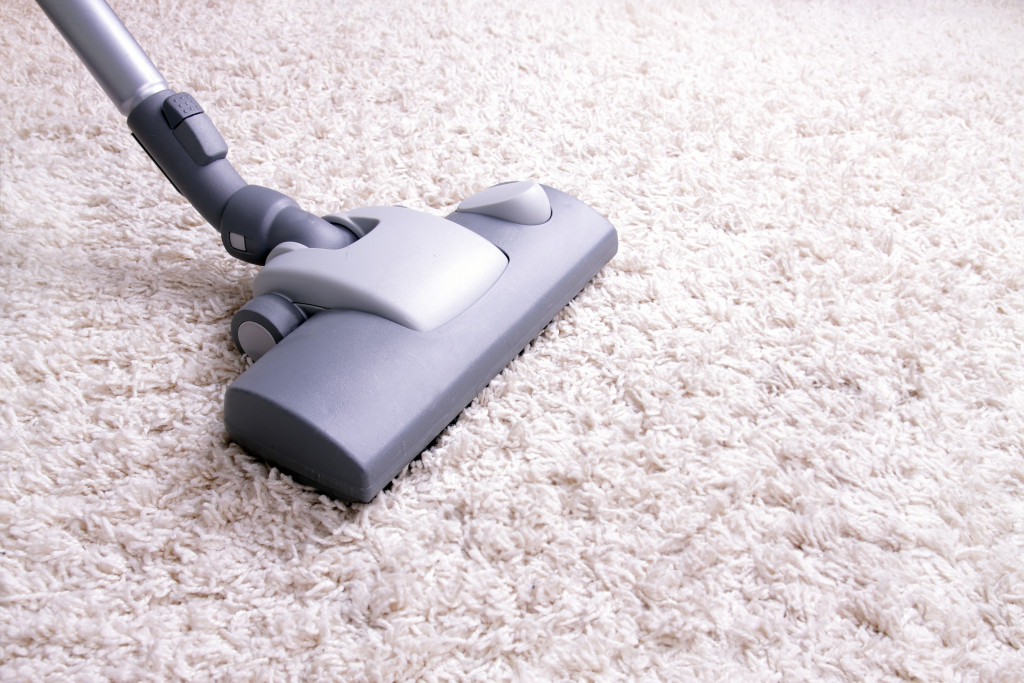 vacuum cleaning the carpet