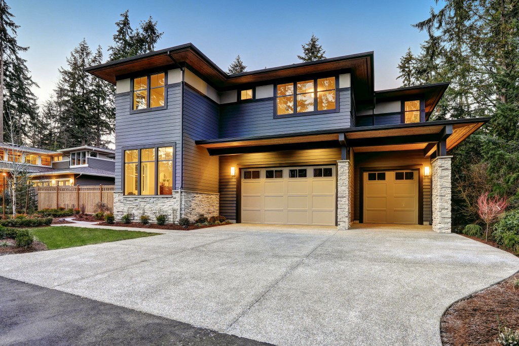 Impressive curb appeal of a home with a wide driveway and small lawn.