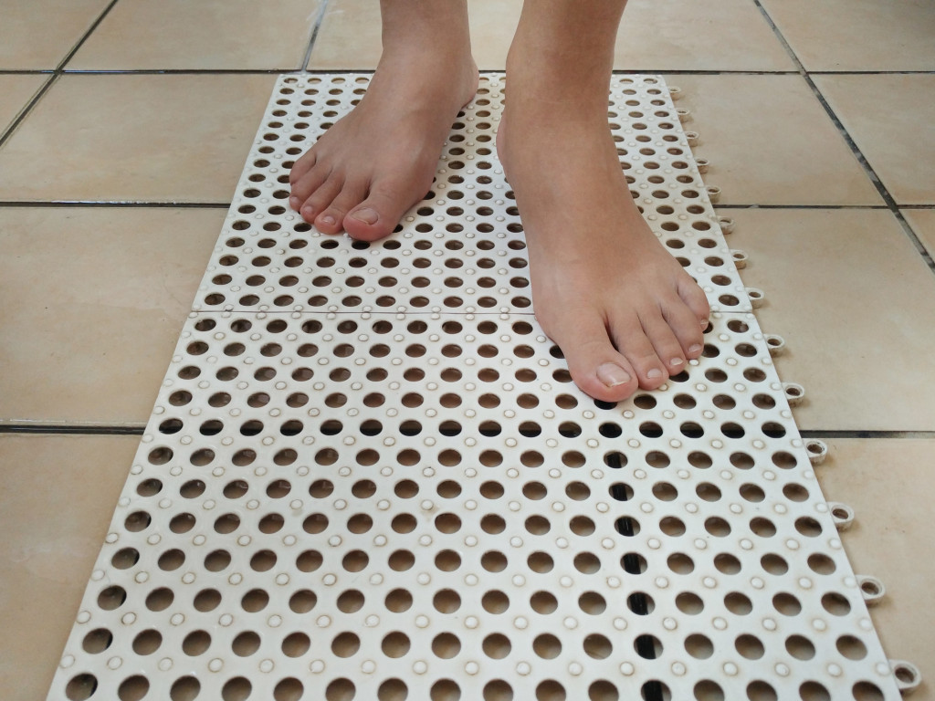 Person walking barefoot on an anti-slip mat.